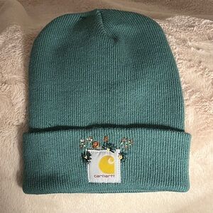 Carhartt Teal Beanie with floral embroidery detail.